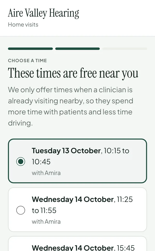 The patient booking page on a phone: 'These times are free near you', with times on Tuesday and Wednesday with Amira.